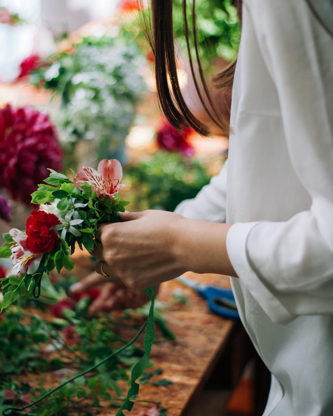 Florist arranging flowers in atelier